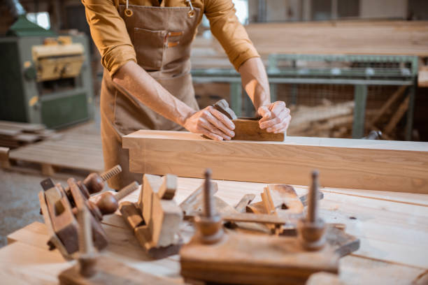 istock Carpenter working with a wood in the workshop 1290546927