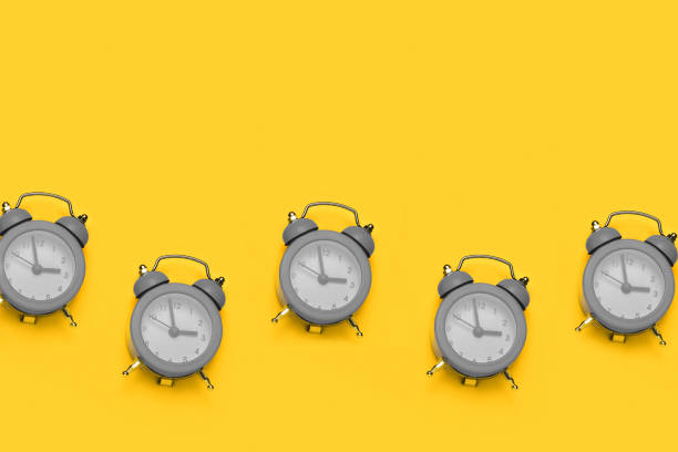 istock gray  clock on a yellow  background, time and deadline concept copy space 1290547623