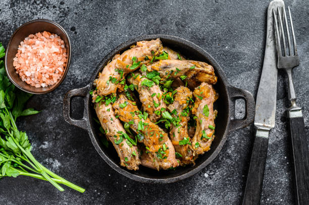 Stew with Chicken Neck meat and vegetables. Black background. Top view