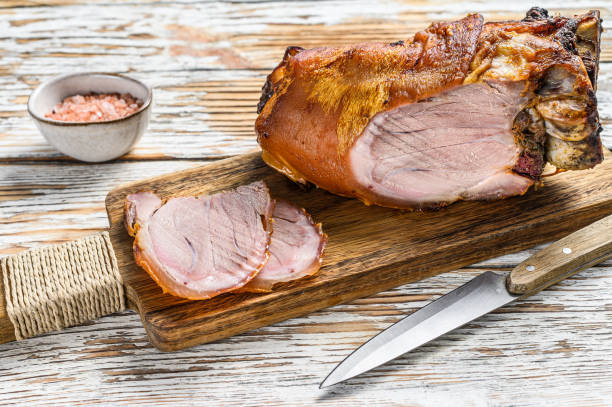 istock Sliced roasted pork knuckle on a cutting board. wooden background. Top view 1290548352