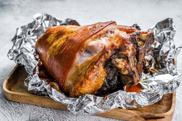 istock Roast pork knuckle with pepper and spices. Gray background. Top view 1290549113