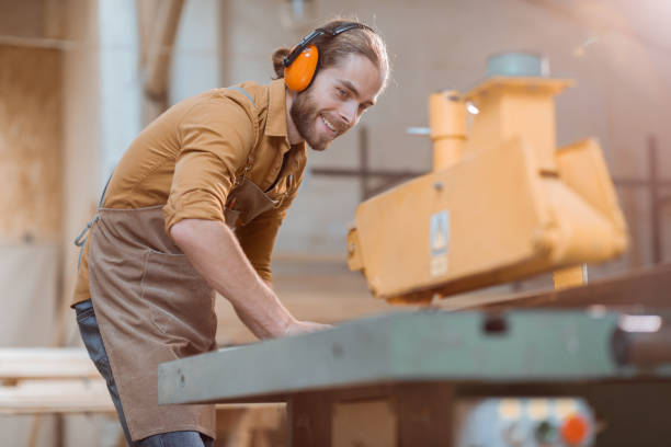 istock Carpenter sawing wooden planks 1290549380