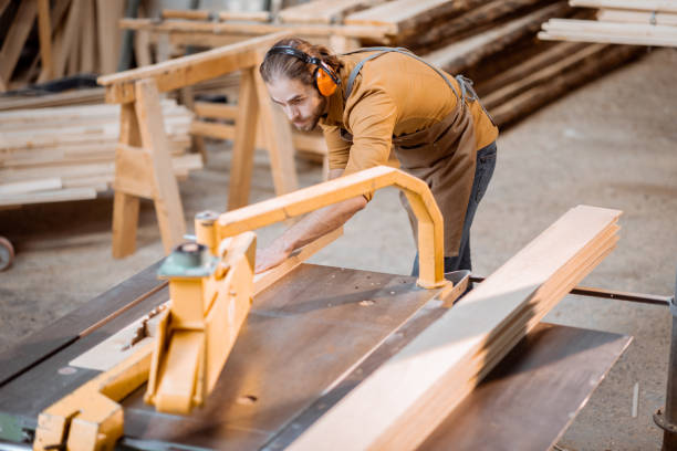 istock Carpenter sawing wooden planks 1290549456