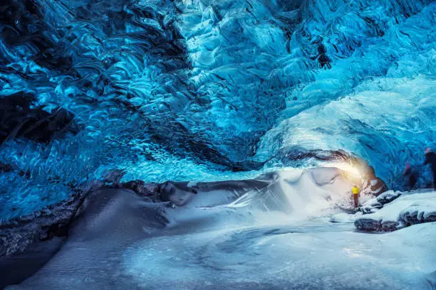 Man in the glacier cave, extreme travel to Iceland, wonderful natural attraction, traveling to Skaftafell, Vatnajokull national park