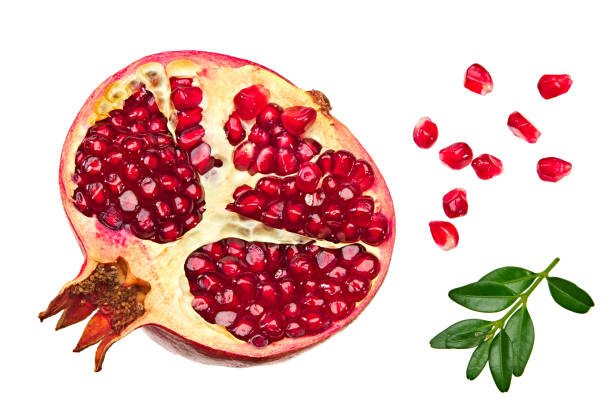istock pomegranate fruit with seeds and green leaves isolated on white background top view 1290549519