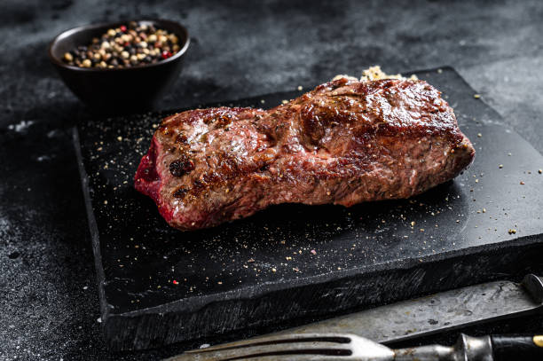 istock Grilled machete or skirt beef steak. Black background. Top view 1290549773