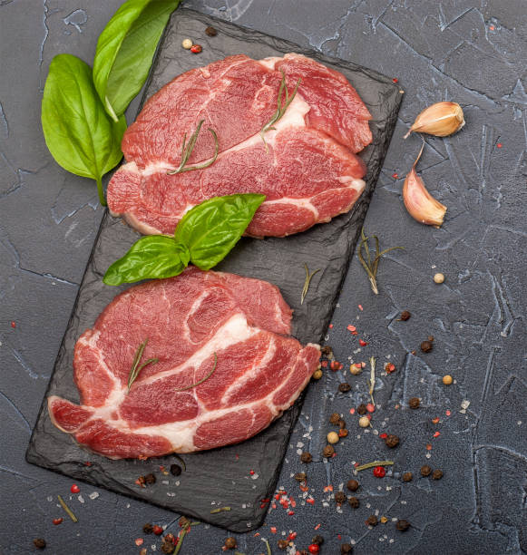 istock Raw fresh meat with spices and rosemary. 1290551785