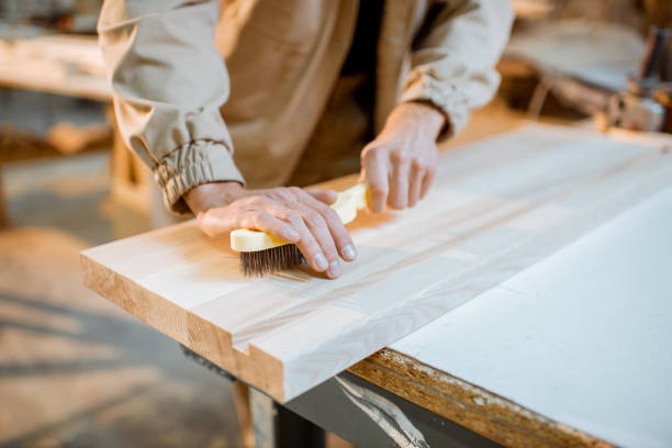 istock Brushing wood with hand brush 1290551961