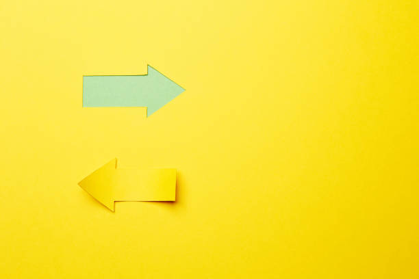 istock Two opposite left/right color paper arrows 1290552524