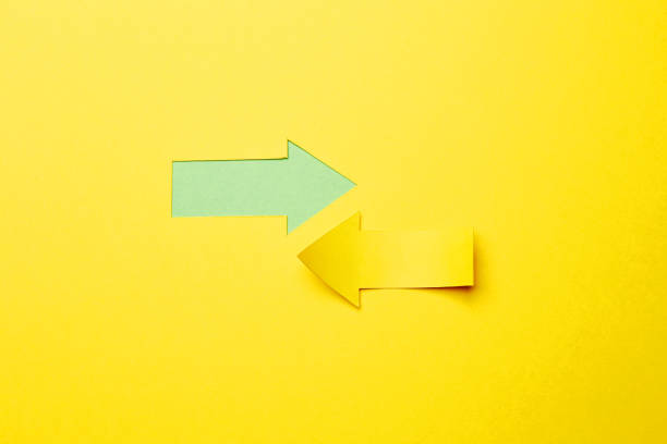 istock Two opposite left/right color paper arrows 1290552525