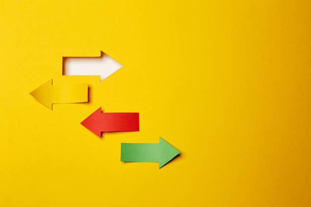 istock Four different direction arrows, cutted from the yellow, red and green paper 1290553123