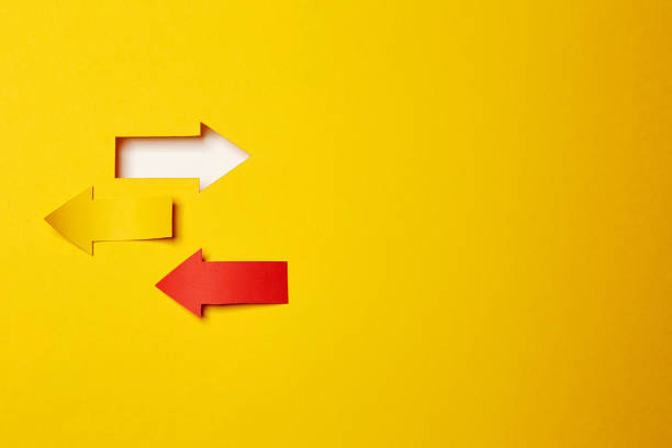 istock Three different direction arrows, cutted from the yellow and red paper 1290553124