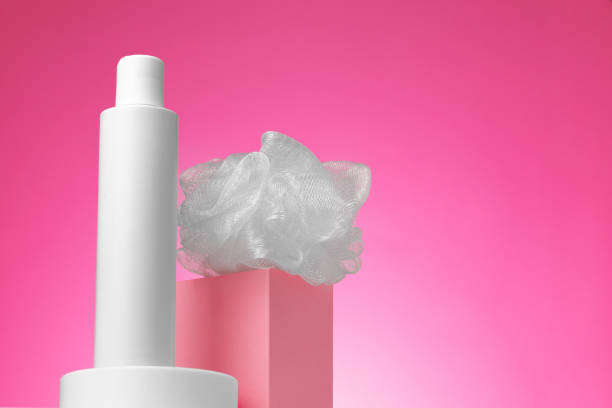 istock Blank cosmetic container and wisp against pink background 1290553184