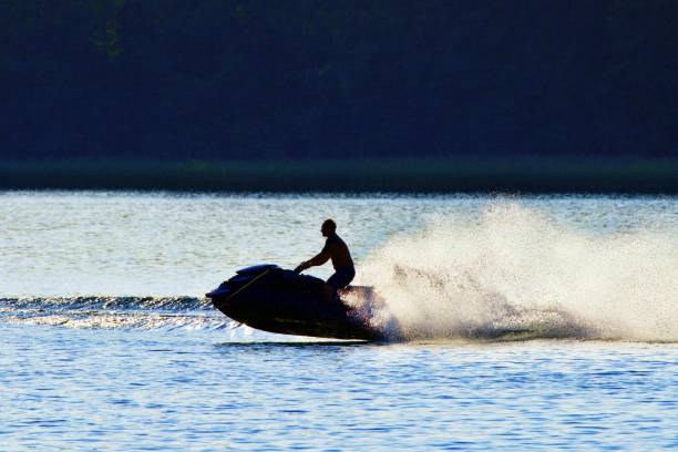 istock Silhouette Man On Boat In Sea Against Sky 1290554488