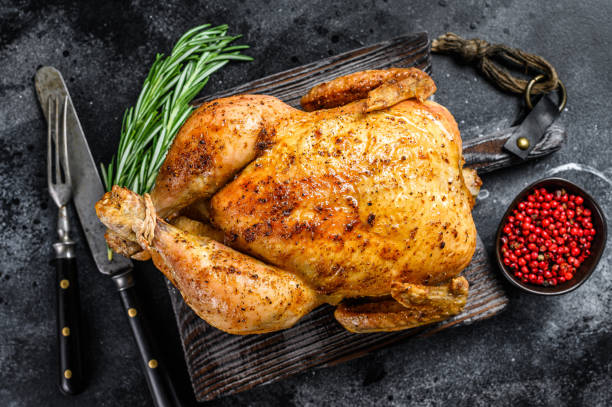 istock Grilled roasted whole Chicken.  Black background. Top view 1290554797