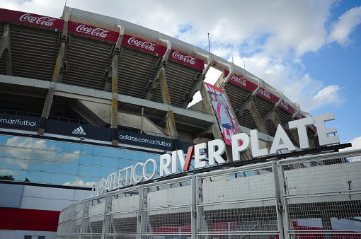 Buenos Aires, Argentina - January, 2020: Home stadium of football club River Plate in Buenos Aires. Full club name sign against stadium stands.