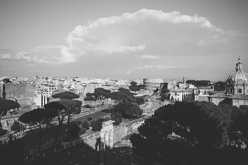 Panoramic view of city Rome with Roman forum and Colosseum from Vittorio Emanuele II Monument also known as the Vittoriano. Summer sunny day and dramatic blue sky