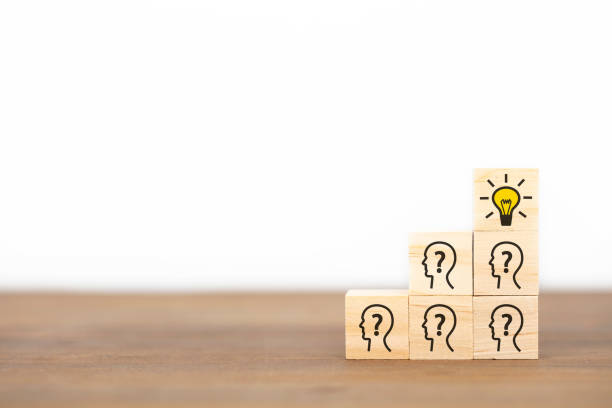 istock Concept creative idea and innovation. wooden cube block with head human symbol and light bulb icon. 1290558722
