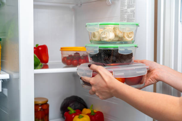 istock Female hands taking storage box with food from a fridge 1290560090