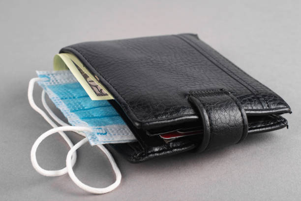 istock Black men's wallet with a medical mask. 1290560242