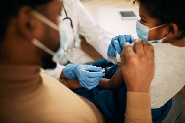 istock Small black boy receiving a vaccine a doctor's office. 1290560333