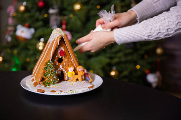 istock A boy decorating Christmas gingerbread house 1290561353