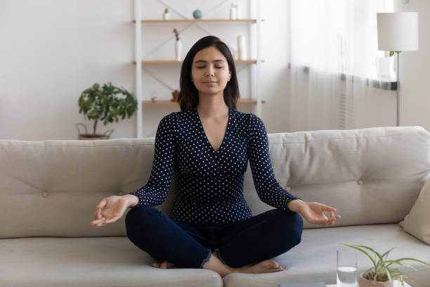 istock Peaceful tranquil Asian woman practicing yoga, sitting in lotus pose 1290561495