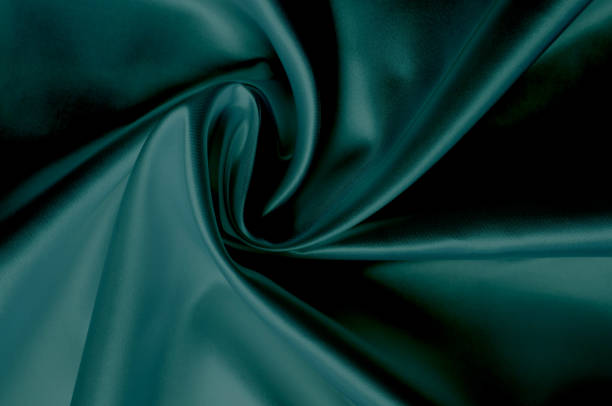 istock Green silk fabric texture close up as background 1290562833
