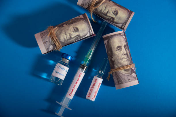istock Dollar, gold and coronavirus vaccine . 1290563930