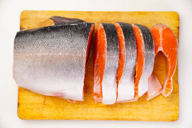 istock salmon sliced into pieces on a wooden cutting Board. red fish. 1290563979