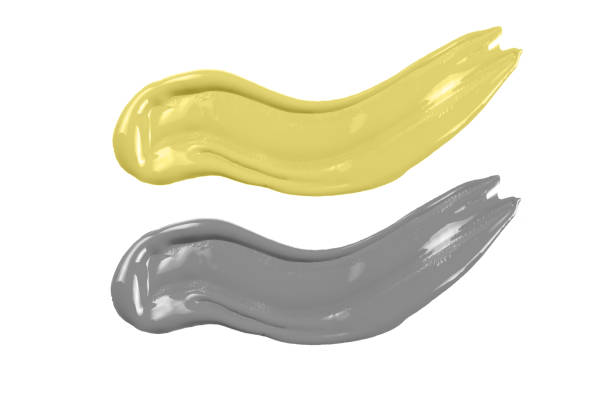 istock Yellow and grey paint isolated on white background. 1290564136