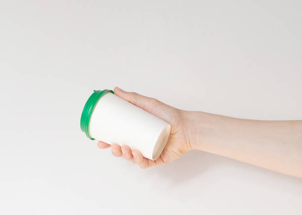 istock Take away coffee cup background. Male hand holding a coffee paper cup 1290564230