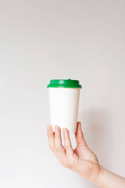 istock Take away coffee cup background. Male hand holding a coffee paper cup 1290564236