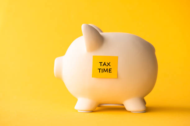 Tax Time Piggy bank with adhesive note. tax season photos stock pictures, royalty-free photos & images