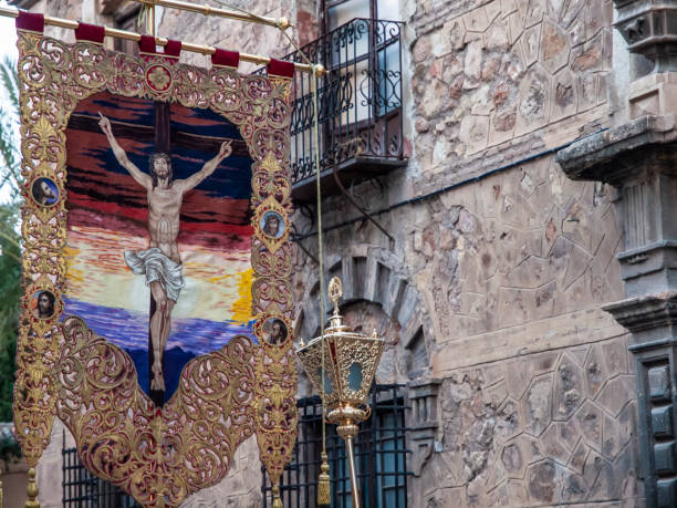 Easter Banner Lorca, Murcia, Spain.  April 17th, 2019.   Banner embroidered with the figure of Jesus Christ on the cross during the Easter processions. lorca stock pictures, royalty-free photos & images