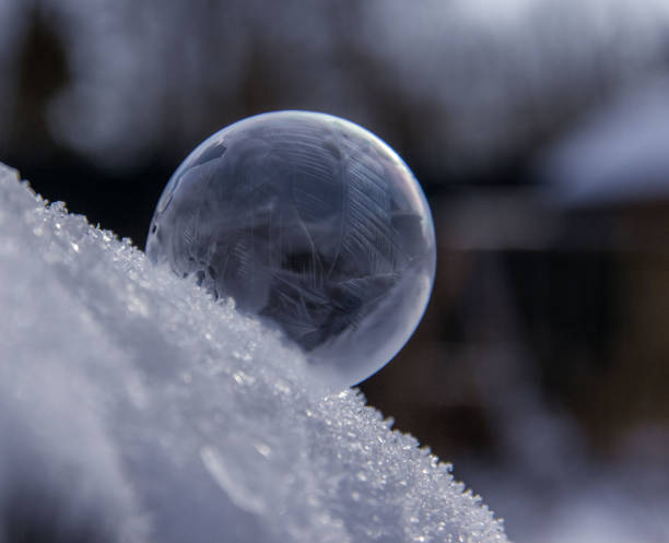 istock Soap bubble frozen in the snow. Crystal formations. Winter background. 1290564938
