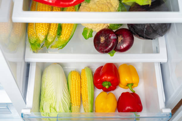 istock Fridge shelf full of fresh vegetables close up 1290565048
