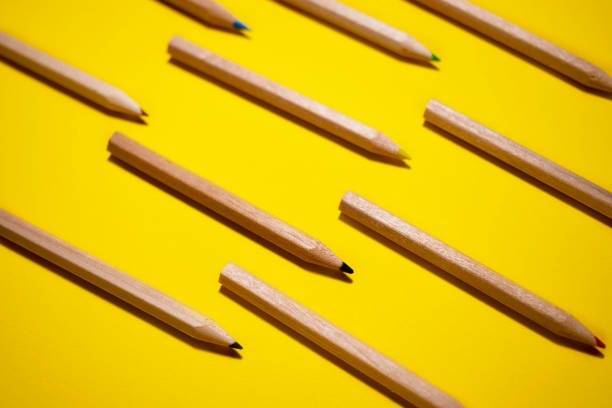 istock The pattern of colored wood pencils on a bright yellow background 1290565739