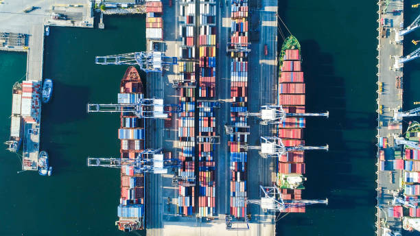 istock Container ship loading and unloading in deep sea port, Aerial view business commercial trading logistic import and export freight transportation, Container loading cargo freight ship maritime 1290566012