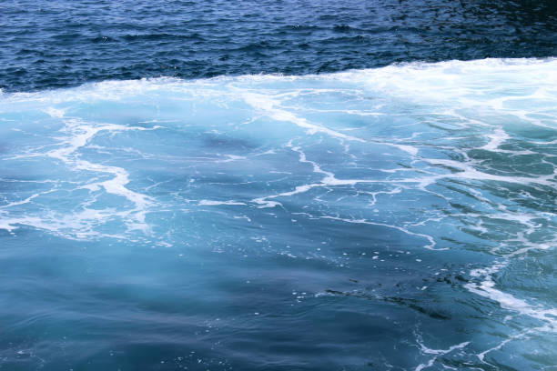 istock Blue sea with waves and foam. 1290566113