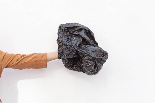 istock Concept of stop plastic pollution, global warming, recycling plastic, plastic free. Hand holding a plastic bag on a white background 1290567020