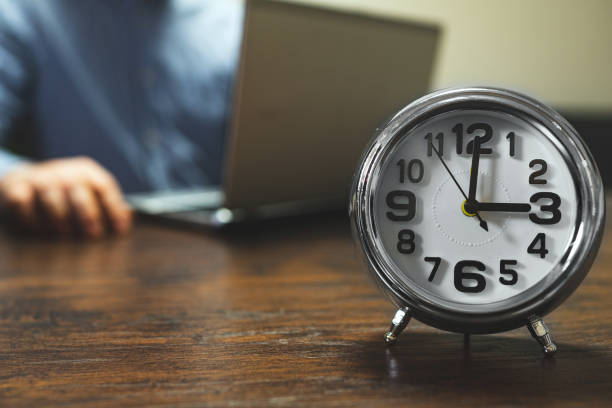 istock The clock shows three o'clock in the afternoon. Working hours are in full swing. 1290568903