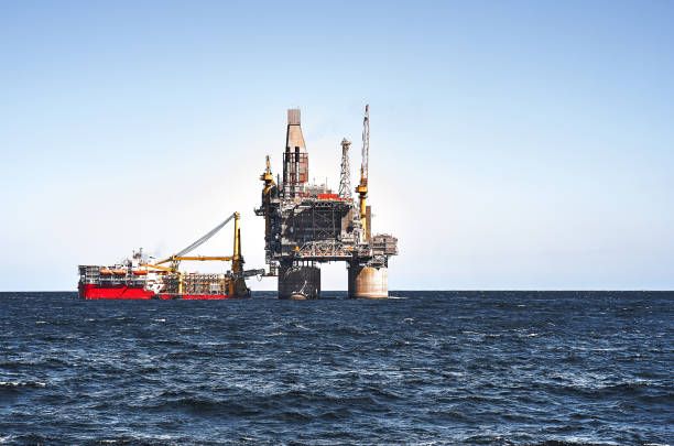 istock Offshore platform and supply ship, sea wave blue clear sky 1290571162