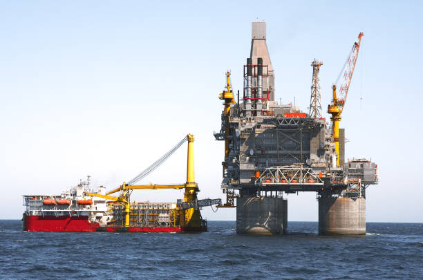 istock Offshore platform and supply ship, sea wave blue clear sky 1290571287