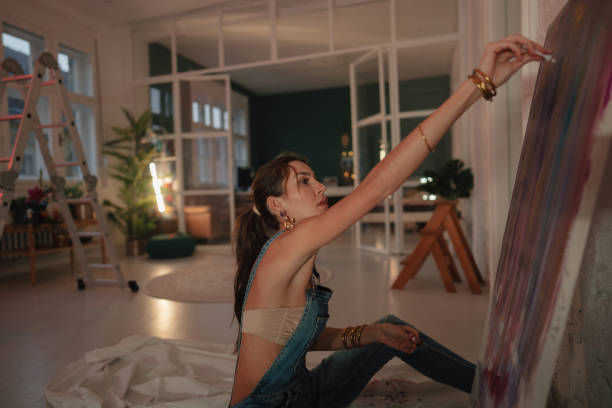 istock Artist painting on canvas 1290572892