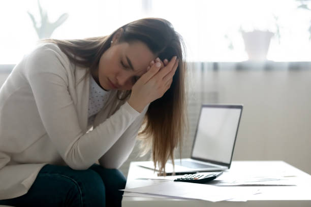 istock Unhappy young woman distressed with financial problems 1290577447