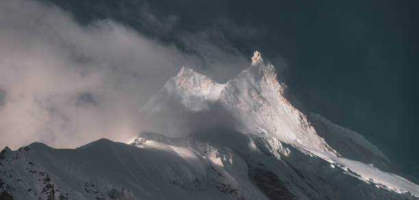istock Manaslu Peak at sunrise with some cloud - 8th highest mountain in the World 1290578977