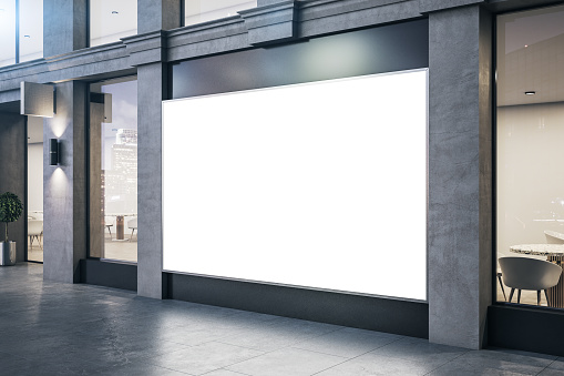 Modern store with blank billboard on vitrine