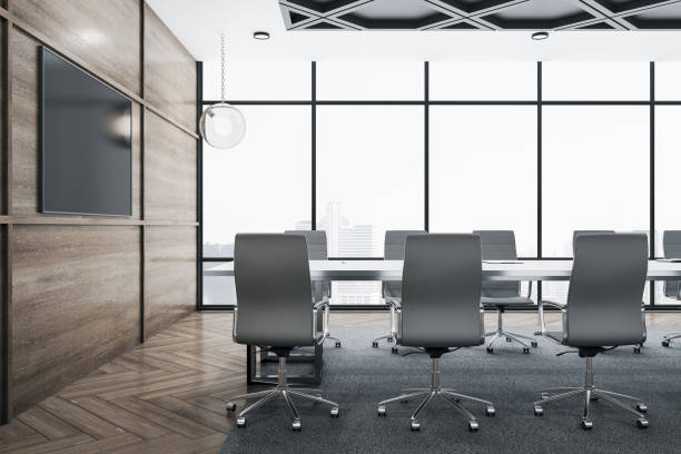 istock Modern meeting interior room with blank plasma screen on wall. 1290582824