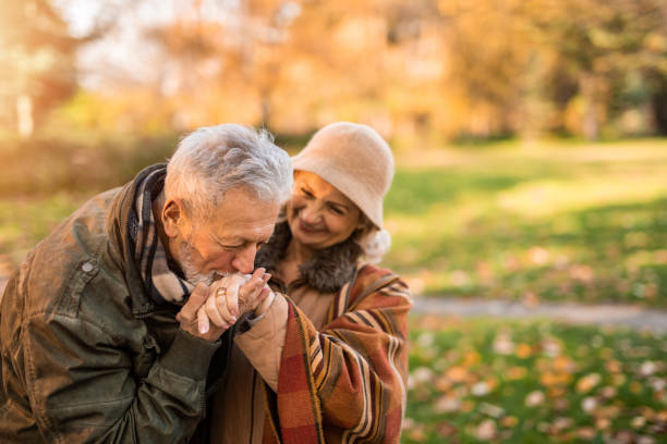 istock Romantic senior man kissing his wife's hand. 1290582846